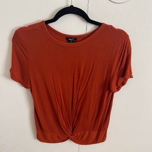Burnt orange basic tee with low knot.